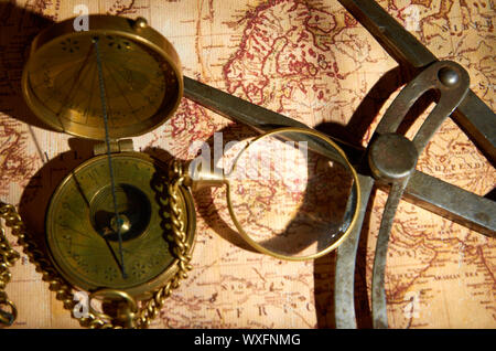 Old compass and magnifying glass lying on the map Stock Photo