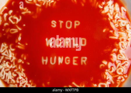 tomato soup with noodle letters message 'stop world hunger' Stock Photo