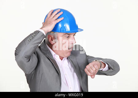 mature architect consulting his watch Stock Photo
