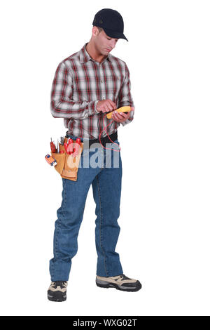 An electrician checking his voltmeter. Stock Photo