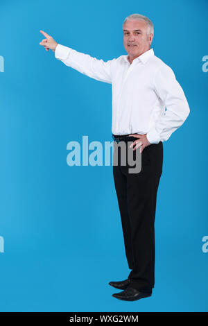 Man pointing to an invisible object Stock Photo