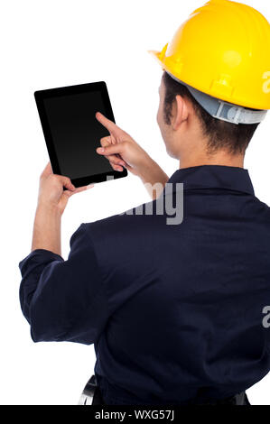 Young construction worker operating touch pad device Stock Photo