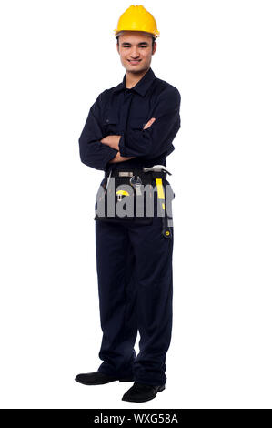 Confident young male worker posing with arms crossed Stock Photo