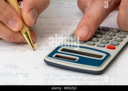 Close up on accountant hand pressing on calculator for calculate monthly benefits , business concept Stock Photo