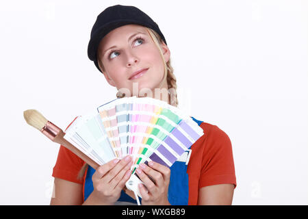 Woman choosing color on swatches Stock Photo