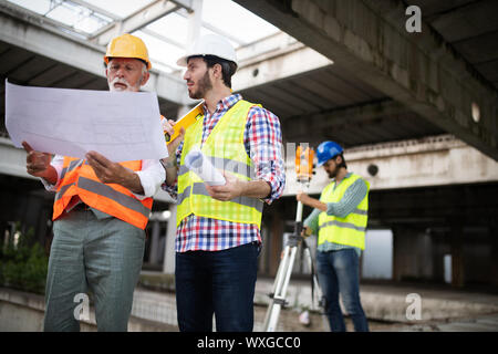 Team of business people in group, architect and engeneer on building site check documents Stock Photo
