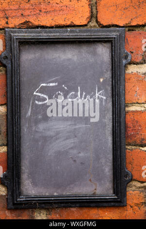 UK, County Durham, Beamish, Museum, Pit Village, Francis Street miner’s cottage, Chalkboard slate in back alley to tell knocker up waking time for shi Stock Photo