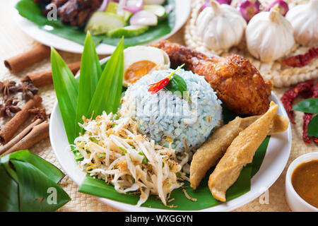 Nasi kerabu or nasi ulam, popular Malaysian Malay rice dish. Blue color of rice resulting from the petals of butterfly-pea flowers. Traditional Malays Stock Photo