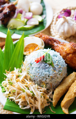 Nasi kerabu or nasi ulam, popular Malaysian Malay rice dish. Traditional east coast blue rice. Famous in states such as Terengganu or Kelantan . Malay Stock Photo