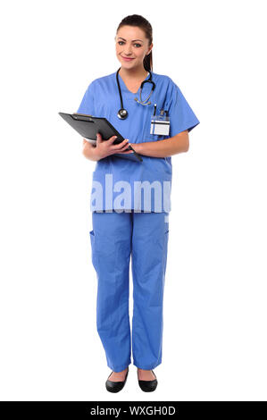 Pretty young medical practitioner posing with clipboard in hands Stock Photo