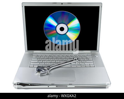 Damaged laptop with a spanner over it and a digital disc on the screen. Isolated on white. Stock Photo