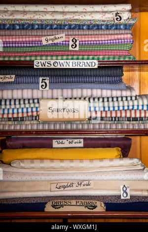 UK, County Durham, Beamish, Museum, Town, Arnfield Plain Industrial Co-Op shop, haberdashery department, shelves filled with cloth Stock Photo