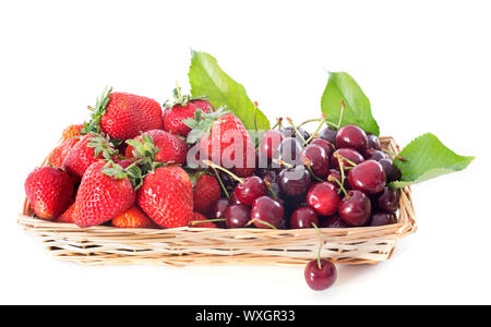 strawberries and cherries in basket in front of white background Stock Photo