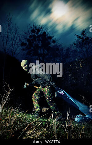 Maniac killer with axe and his victim at night Stock Photo - Alamy