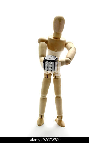 Wooden manikin holding dice Stock Photo