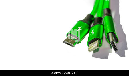 three cord charger to a green smartphone isolate on white background Stock Photo