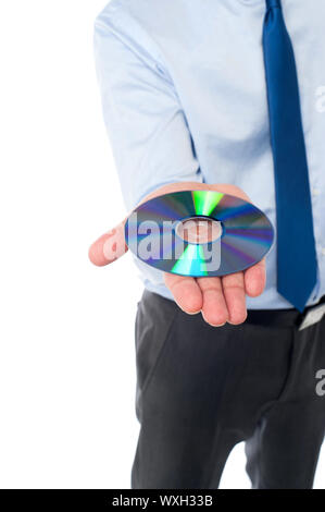 Cropped image of male executive showing compact disc Stock Photo