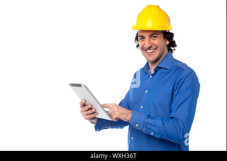 Young construction worker operating touch pad device Stock Photo