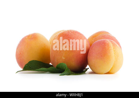 Sweet peaches with leafs on a white background Stock Photo