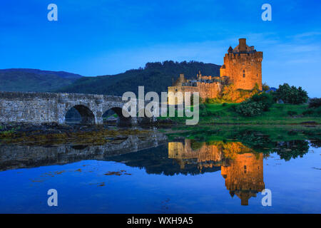 Eilean Donan Castle in the evening. The castle is built in a small island where three lochs converge - Loch Alsh, Loch Long, and Loch Duich. Stock Photo