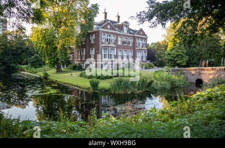 Rotterdam, Netherlands. June 29, 2019. Villa Jamin surrounded by nature. A peaceful river flowing under a bridge. Destination for vacation. Stock Photo