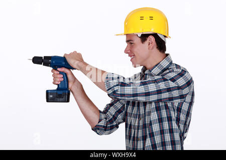 Tradesman holding a power tool Stock Photo