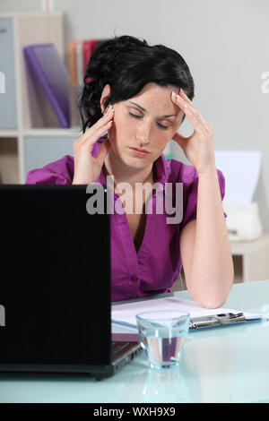 Businesswoman suffering from migraine Stock Photo
