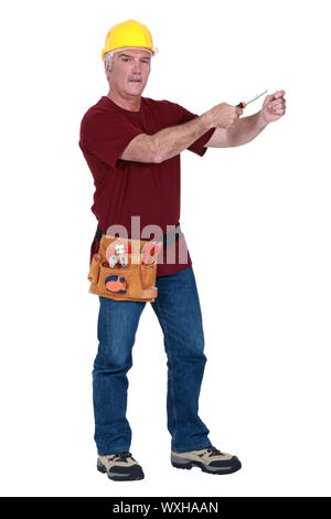 Grey-haired man holding screw-driver Stock Photo