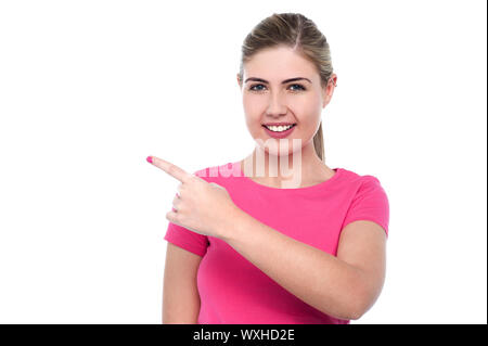 Cheerful pretty girl pointing towards something Stock Photo