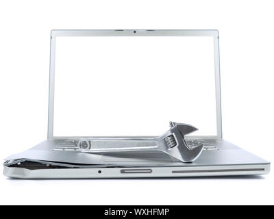 A spanner over a damaged laptop isolated over white background. White copy space on screen. Stock Photo