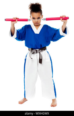 Karate girl getting ready to fight with nunchucks Stock Photo