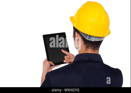 Young construction worker operating touch pad device Stock Photo