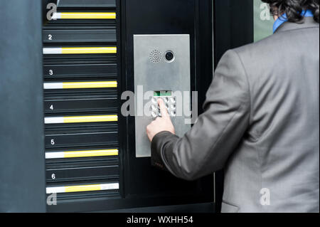 Businessman entering safe code to unlock the door Stock Photo