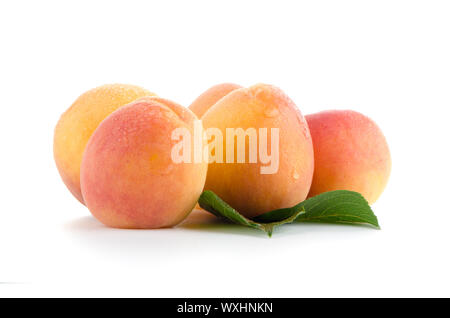 Sweet peaches with leafs on a white background Stock Photo