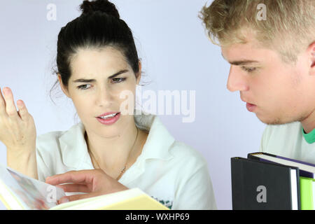 A couple of teens discussing study lessons Stock Photo