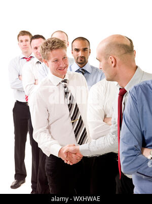 Businessmen shaking hands standing in a group Stock Photo