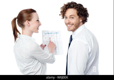 Business executives discussing annual report Stock Photo