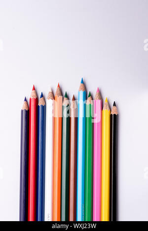 Colored pencils arranged on an isolated white background Stock Photo
