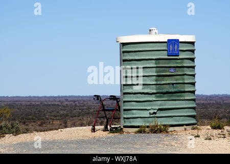 Mobility Walker resting against an Outback Dunny along the Barrier Highway Stock Photo