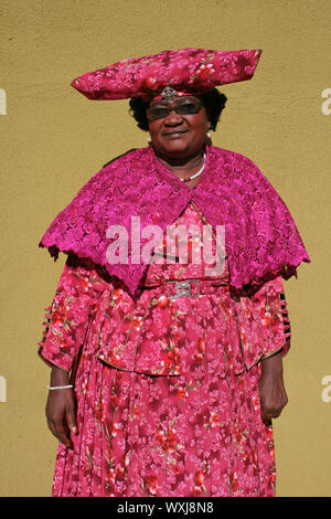 Herero Woman Wearing Traditional dress 'Ohorokova' and headdress 'Otjikaiva' , Katutura, Windhoek, Namibia Stock Photo