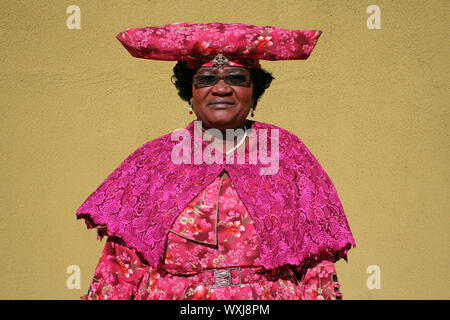 Herero Woman Wearing Traditional dress 'Ohorokova' and headdress 'Otjikaiva' , Katutura, Windhoek, Namibia Stock Photo