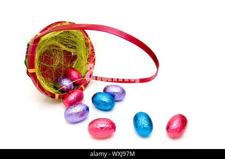 Easter eggs falling out of the basket on a white background Stock Photo