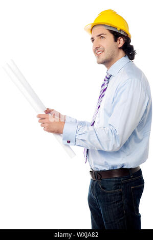 Architect in hard hat holding out construction plan Stock Photo