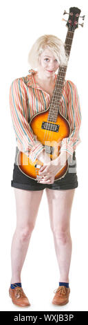 Coy blond female holding guitar on isolated background Stock Photo
