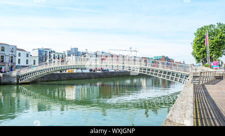 DUBLIN, IRELAND - AUGUST 1, 2019: Halfpenny Bridge over River Liffey, Dublin, Ireland. Stock Photo