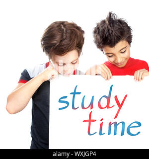 Portrait of two happy boys holding white chalkboard with written phrase ' study time', isolated on white background, education concept Stock Photo