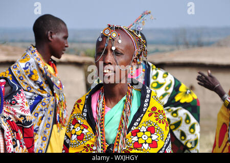 MASAI MARA NATIONAL RESERVE, KENYA- 19.August 2010. Masai woman and singing and doing a welcome dance. Stock Photo