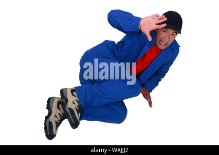 Terrified man lying on the floor Stock Photo