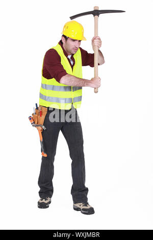 Man using a pickaxe Stock Photo