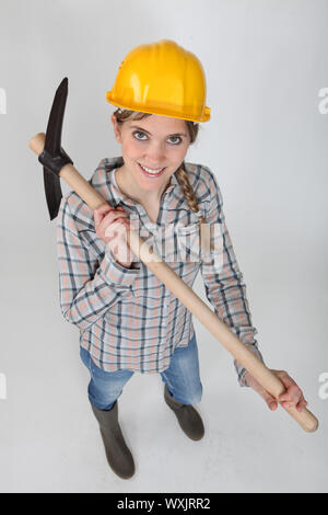 Tradeswoman holding a pickaxe Stock Photo